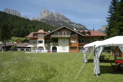 a large house with a tent in front of it at Residence Holiday in Pozza di Fassa