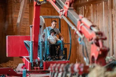 two people sitting in the front of a bulldozer at Kierhof Chalets in Velturno