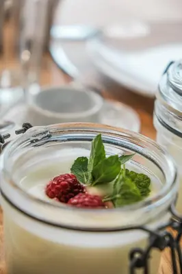 a jar of a drink with a raspberry in it at Kierhof Chalets in Velturno