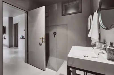 a bathroom with a shower and a white sink at Stufels 7 Design Apartment with Brixen Card in Bressanone