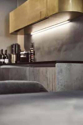 a kitchen with a counter top and a light at Stufels 7 Design Apartment with Brixen Card in Bressanone