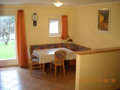 a dining room with a table and chairs at Appartments Am Wiesenrand in Nova Ponente