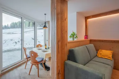 a living room with a couch and a table at Cesa La Doe Majons in Campitello di Fassa