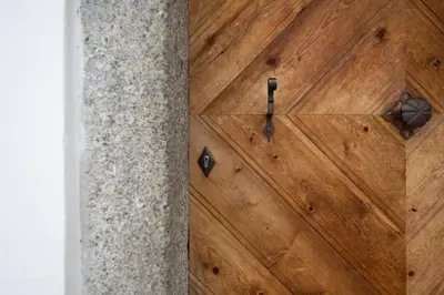 a wooden door with a metal knocker on it at Ban Hilba in Falzes