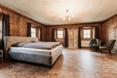 a bedroom with a bed and wooden walls at Ban Hilba in Falzes