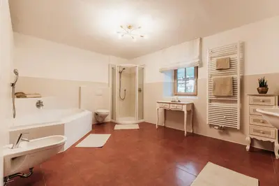 a bathroom with a tub and a toilet and a sink at Ban Hilba in Falzes