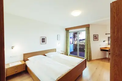 a bedroom with a large bed and a window at Ferienwohnung Pension Stern in Aldino