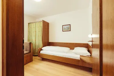 a bedroom with a bed with white pillows at Ferienwohnung Pension Stern in Aldino