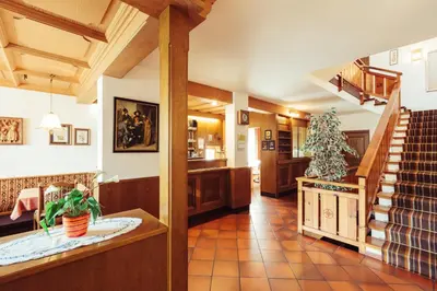a large room with a staircase and a stair case at Ferienwohnung Pension Stern in Aldino