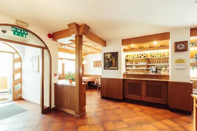a restaurant with a counter and a bar at Ferienwohnung Pension Stern in Aldino