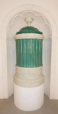 a green and white vase sitting on a table at Lauben Suite Old Town Bolzano in Bolzano