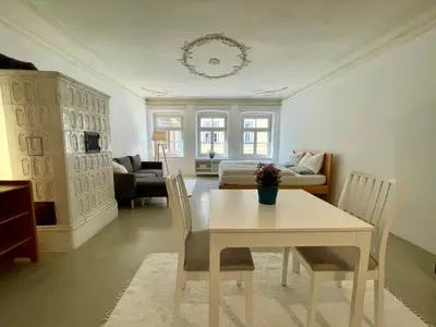 a living room with a table and chairs and a couch at Lauben Suite Old Town Bolzano in Bolzano