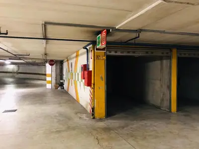 an empty parking garage with a fire truck in it at Lauben Suite Old Town Bolzano in Bolzano