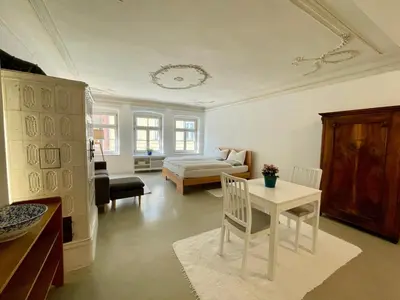 a living room with a bed and a table at Lauben Suite Old Town Bolzano in Bolzano
