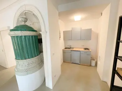 a kitchen with a large green object in a room at Lauben Suite Old Town Bolzano in Bolzano