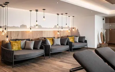 a living room with two couches in a room at Pippos Mountain Lodge in Soprabolzano