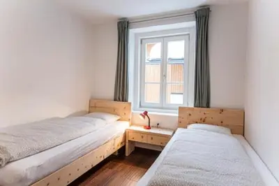 two beds in a room with a window at vedla posta in Badia