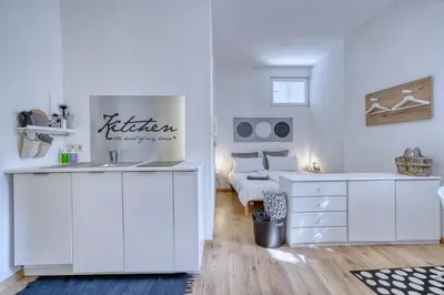 a white room with a sink and a bed at HOMESTWENTY3 - Home five in Caldaro