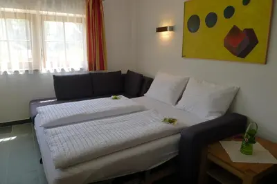 a living room with a couch and a table at Haus Pichler Apartment in Collalbo