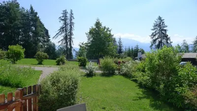 a garden with a fence and some bushes at Haus Pichler Apartment in Collalbo