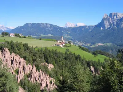 a view of a mountain with a house and trees at Haus Pichler Apartment in Collalbo