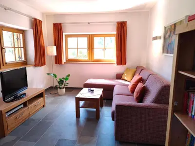 a living room with a couch and a tv at Haus Pichler Apartment in Collalbo