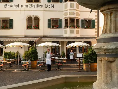 a couple of people standing in front of a building at Weisses Rössl in Caldaro