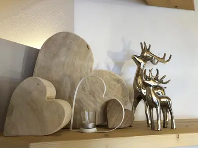 a wooden shelf with a statue of a deer on it at Attico Faloria Luxury in Moena