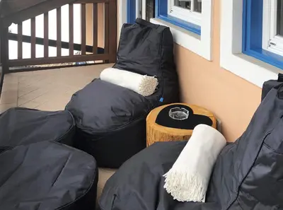 two bean bags sitting on a balcony with a table at Attico Faloria Luxury in Moena