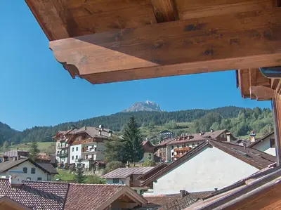 a view of a town with a mountain in the background at Attico Faloria Luxury in Moena