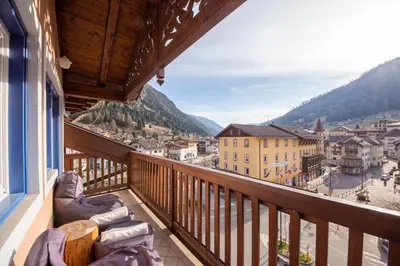 a balcony with a view of a city at Attico Faloria Luxury in Moena