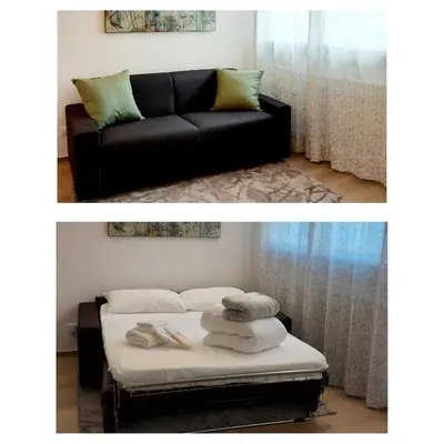 a living room with a couch and a bed at MAISON MY LIFE in Bolzano