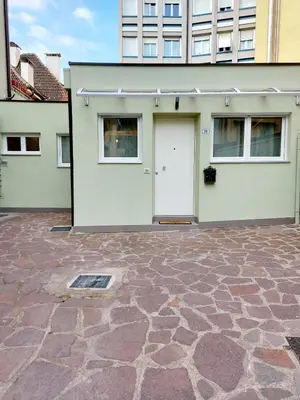 a house with a white door and a stone driveway at MAISON MY LIFE in Bolzano