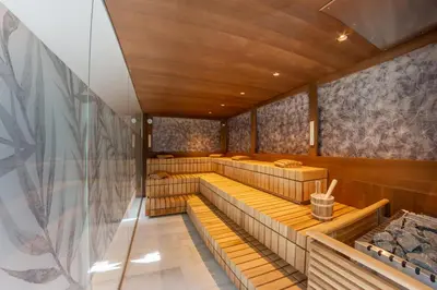 a row of benches in a room with wooden ceilings at Tyrol family retreat in Naturno