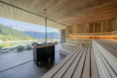 a room with a bench and a view of the mountains at Ansitz Velseck-Residence Hotel in Tires
