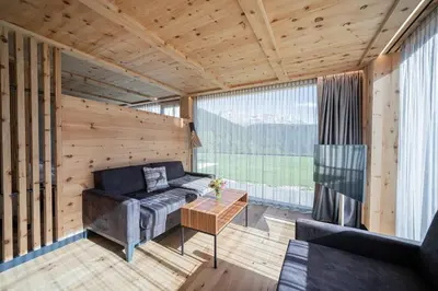 a living room with a couch and a table at Ansitz Velseck-Residence Hotel in Tires