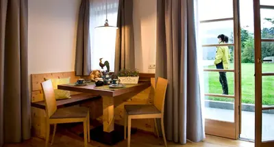 a dining room with a table and chairs and a window at Ansitz Velseck-Residence Hotel in Tires