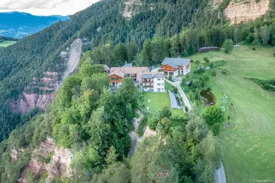 an aerial view of a house on a mountain at Ansitz Velseck-Residence Hotel in Tires