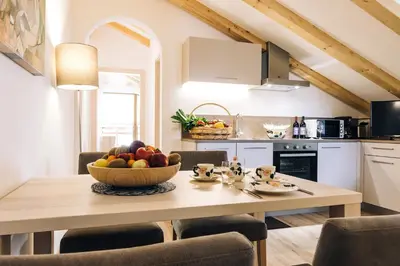 a kitchen with a table with a bowl of fruit on it at Residence Paulserhof in Appiano sulla Strada del Vino