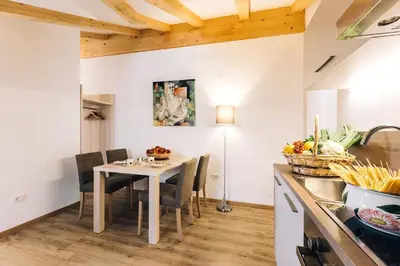 a kitchen and dining room with a table and chairs at Residence Paulserhof in Appiano sulla Strada del Vino