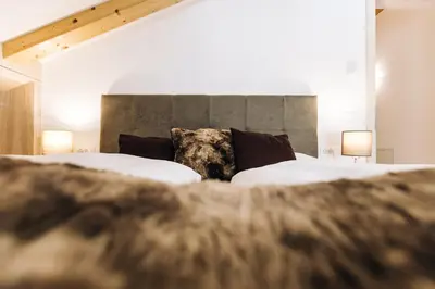 a bedroom with two beds and two lamps at Residence Paulserhof in Appiano sulla Strada del Vino