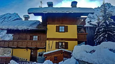 a large house with snow on the roof at B&B Cesa Marlen in Canazei