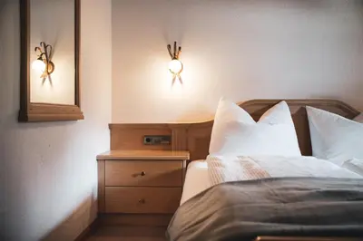 a hotel room with a bed and a window at Hotel B&B Frohsinn in Badia