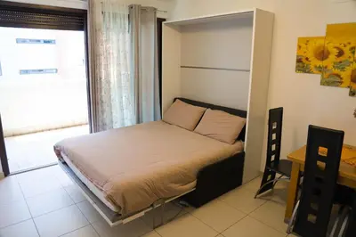 a bedroom with a bed in a room with a window at Casa Margherita in Bolzano