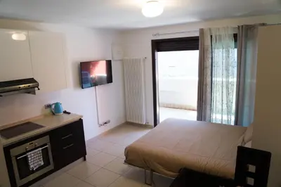 a small bedroom with a bed and a television at Casa Margherita in Bolzano