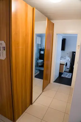 a hallway with a door leading to a bathroom at Casa Margherita in Bolzano