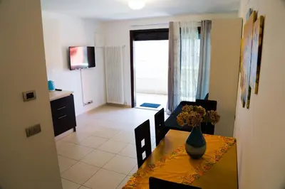 a living room with a table with a vase on it at Casa Margherita in Bolzano