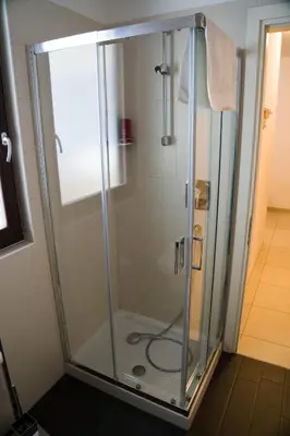 a shower with a glass enclosure in a bathroom at Casa Margherita in Bolzano