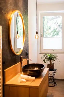 a bathroom with a black sink and a mirror at Marlingsuites in Marlengo