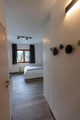 a room with a bedroom with a bed and a window at Modern studio apartment in the heart of Merano in Merano
